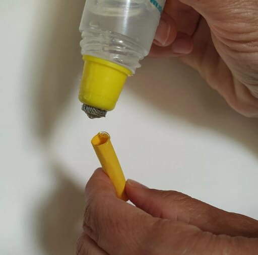 Glue the yarn ball to the paper pencil topper.