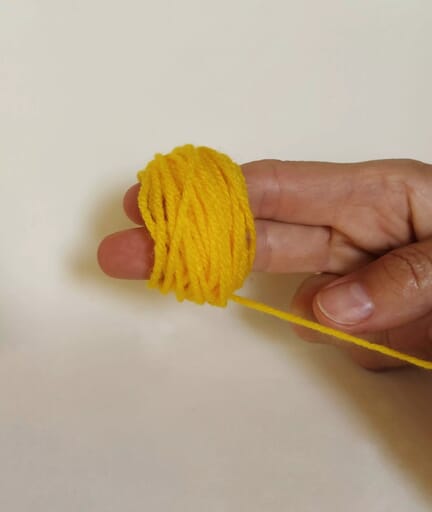 Easy 7 Step Cute Little Chicken Pencil Topper Craft Wrap yarn around two fingers.